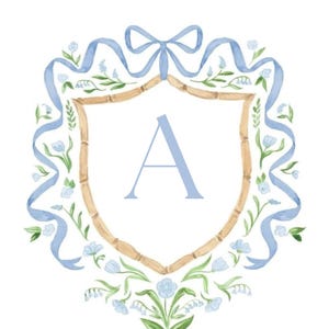 May include: A watercolor illustration featuring a central shield with a bamboo-style border and the letter A in light blue. The shield is surrounded by a light blue ribbon tied in a bow at the top, accented with small blue flowers and green leaves.