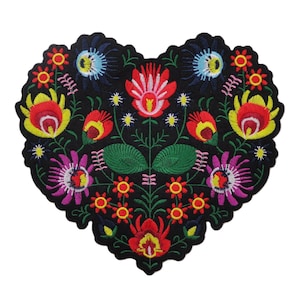 May include: Embroidered heart-shaped patch featuring a vibrant floral design. The patch showcases a black background with colorful flowers in red, yellow, pink, and blue. The patch is approximately 4 inches wide and 4 inches tall.