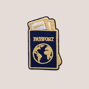 May include: A blue passport with a gold embroidered globe and the word "PASSPORT" on the front.