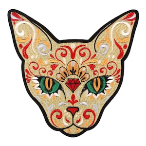 May include: Embroidered cat patch with a gold background and intricate floral designs in red, orange, and silver. The cat's eyes are green with orange pupils, and a red diamond is centered on its forehead. The patch has a black border.