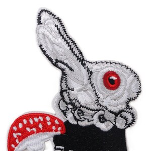 Embroidered rabbit with red toadstool patch in rockabilly and folklore style, iron-on applique for jackets, bags, or clothing.jpg