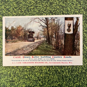 May include: A black and red steam roller is driving down a dirt road lined with trees. The road is being built by the steam roller. A sign on a tree reads "CASE Steam Roller building Country Roads Price, cash, $1980; on time, $2200, "Warranted to do all or anything that can be done by any 10-ton Steam Roller." J. I. CASE THRESHING MACHINE CO., Incorporated, Racine, Wis."