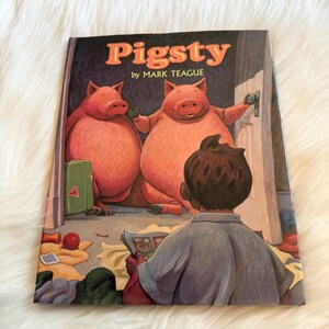 May include: A children's book titled "Pigsty" by Mark Teague. The cover features two large pink pigs, a boy reading a newspaper, and a green suitcase. The background is a dark room with a door.