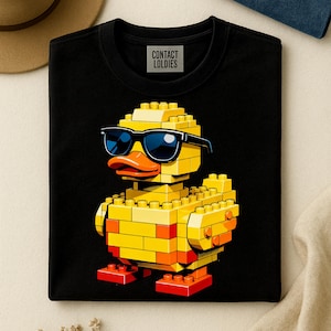May include: Black crew neck sweatshirt featuring a yellow and orange Lego-style duck wearing sunglasses. The duck has an orange beak and red feet. The text "CONTACT LOLDIES" is printed on the upper left of the sweatshirt.