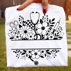 May include: White t-shirt featuring a black and white floral design with medical tools, including a stethoscope, syringe, and thermometer. The design also includes scissors and a checkered pattern. The shirt has a blank space for personalization.
