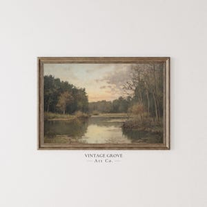 May include: A framed painting depicting a lake scene with trees lining either side of the water. The sky is a soft blue with a few clouds. The water is calm and reflective. The painting is in a brown frame.