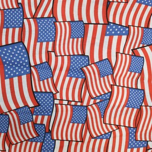 May include: A close-up of a fabric pattern featuring many American flags in red, white, and blue. The flags are arranged in a chaotic, overlapping pattern, creating a sense of movement and patriotism.