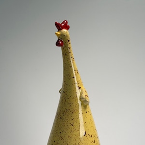 May include: A set of three ceramic mugs with a speckled, matte finish. The mugs are in shades of cream, light brown, and dark brown. Each mug has a simple, minimalist design, perfect for coffee or tea.