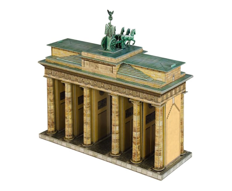 May include: A detailed model of the Brandenburg Gate, featuring a green Quadriga statue atop a tan and green structure. The model has multiple columns and a detailed facade, showcasing architectural elements.