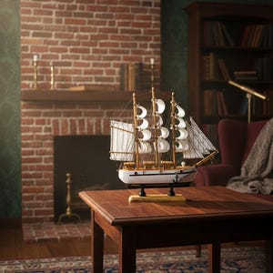 May include: A detailed wooden model of a sailing ship with white sails and a white hull, displayed on a dark wooden table. The ship model has intricate rigging and is set against a backdrop of a brick fireplace and a cozy living room setting.