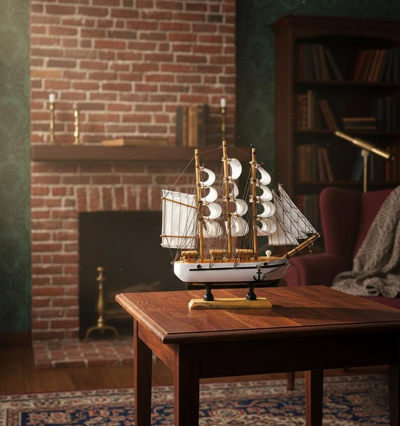 May include: A detailed wooden model of a sailing ship with white sails and a white hull, displayed on a dark wooden table. The ship model has intricate rigging and is set against a backdrop of a brick fireplace and a cozy living room setting.