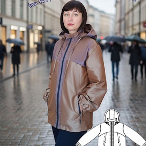 Könnte beinhalten: Ein brauner und violetter Windbreaker-Regenmantel mit Kapuze und Reißverschluss. Der Text auf dem Bild lautet: "Das Schnittmuster für die Windbreaker-Regenmantelgrößen reicht von US 6 / EU 38 bis US 12 / EU 48."