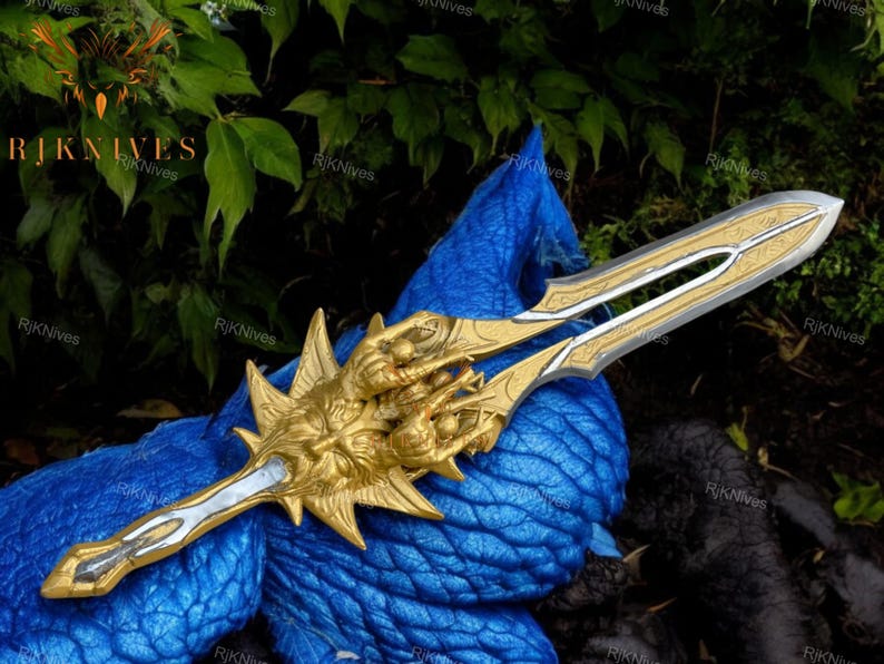 May include: A gold and silver sword with a detailed design. The sword has a golden handle with a dragon head and claws. The blade is silver with intricate engravings.