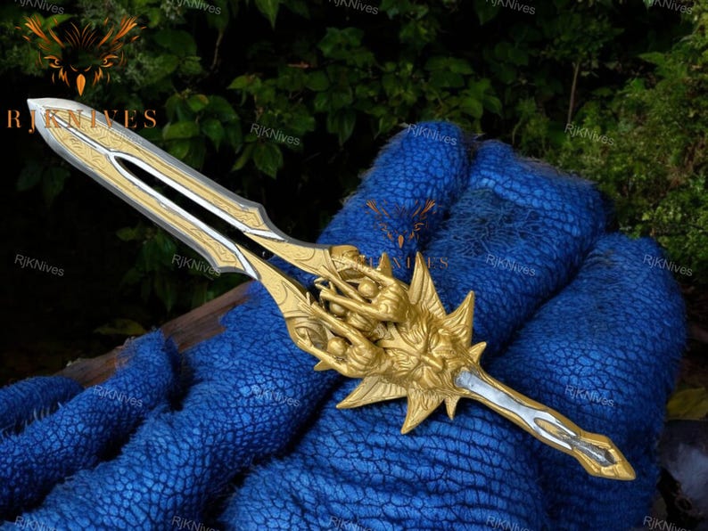 May include: A gold and silver sword with a detailed design. The sword has a handle with a sculpted design of a face with multiple hands.