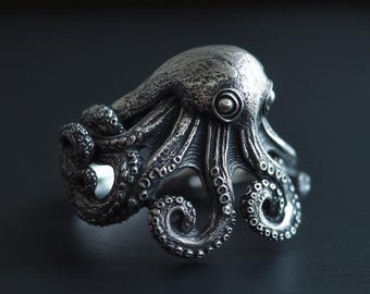 May include: A silver octopus ring with detailed tentacles and a textured surface.
