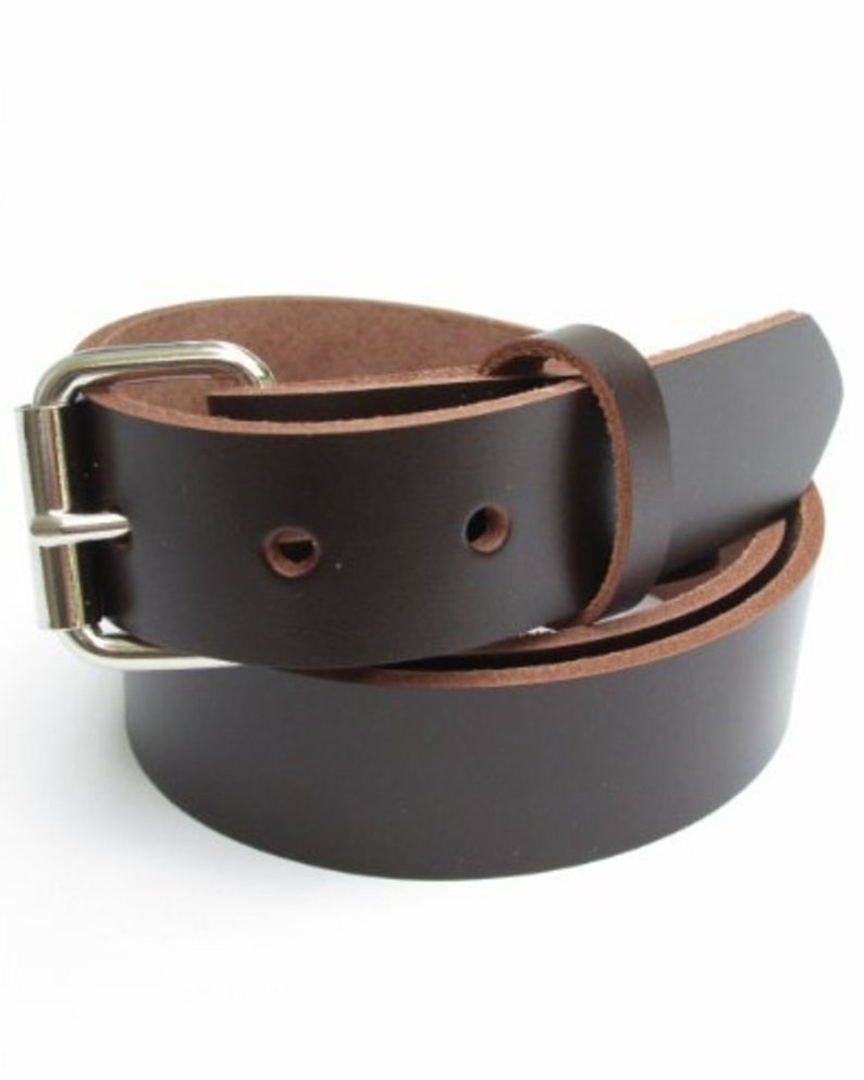 May include: A brown leather belt with a silver buckle. The belt is rolled up and the buckle is visible.
