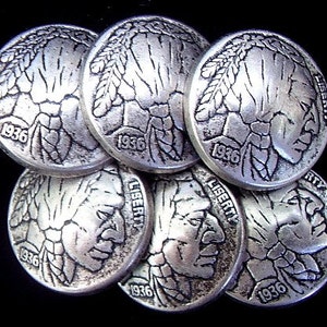 May include: A collection of seven silver-toned Buffalo nickels, each displaying a profile of a Native American and the year 1936. The word "LIBERTY" is visible on some coins. The nickels are stacked against a black background.