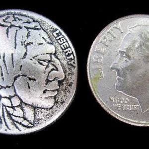 May include: Two silver coins on a black background. One coin features a Native American profile with the year 1936. The other coin shows a profile of a man with the year 1988. Both coins have the word "LIBERTY" on them.
