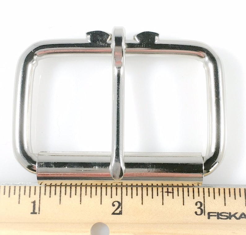 May include: Silver metal buckle for a belt, measuring 1 inch wide. The buckle is designed to be used with a 1 inch wide belt.