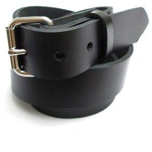 May include: A black leather belt with a silver buckle. The belt is folded in half and the buckle is visible.
