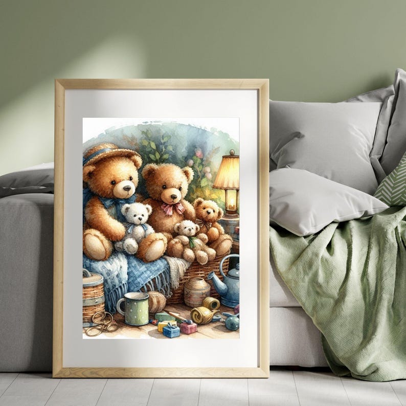 May include: Watercolor print of a framed image featuring a group of teddy bears. The bears are brown and white, sitting in a wicker basket with a blue blanket. A lamp, mug, and other decorative items are also present.