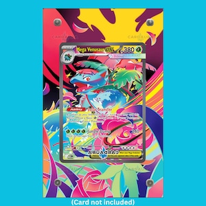 May include: A framed Mega Venusaur EX trading card with a vibrant background. The card shows a blue and green creature, with text including "Mega Venusaur EX" and "Solar Transfer". The frame is held together with silver screws.