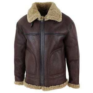 May include: A brown leather jacket with a shearling collar and lining. The jacket has a full zipper closure and shearling trim along the cuffs and hem. The jacket has a classic aviator style.