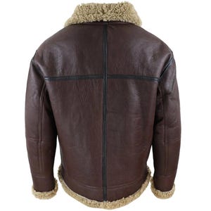 May include: A brown leather jacket with a shearling collar and lining. The jacket has a classic design with a dark brown exterior and tan shearling trim around the collar, cuffs, and hem. Black stitching details are visible on the back.