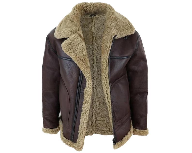 May include: A brown leather jacket with a shearling lining and collar. The jacket has a zip closure and a classic aviator style. The interior and collar are a light tan color, contrasting with the dark brown exterior.