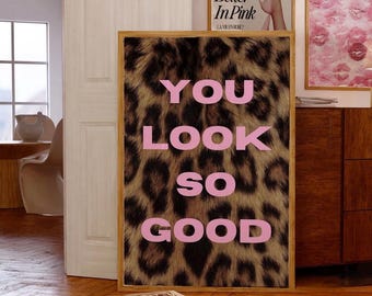 May include: A framed print with a leopard print background and the words "YOU LOOK SO GOOD" in pink letters.