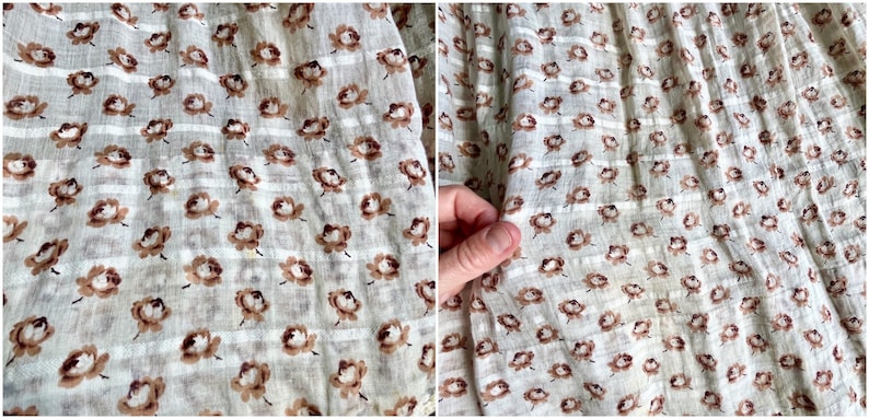 May include: Close-up of a white fabric with a brown floral pattern. The fabric has a subtle striped texture.