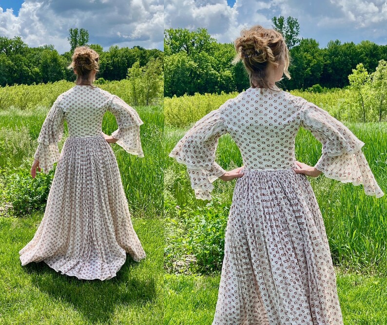 May include: A white dress with a floral pattern and long sleeves with ruffles. The dress has a fitted bodice and a full skirt.
