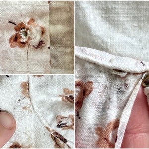 May include: Close-up of a white fabric with a floral pattern. The fabric has a frayed edge and a small hole. The fabric is likely a garment, such as a shirt or dress.