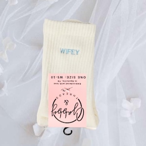 a pair of white grip socks with the word "wifey" embroidered on them