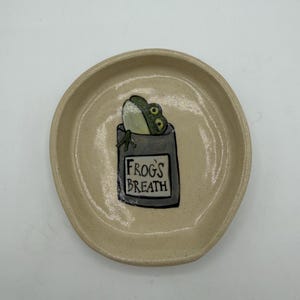 May include: A set of three ceramic mugs with a speckled, matte finish. The mugs are in shades of cream, light gray, and dark gray. Each mug has a simple, minimalist design, perfect for coffee or tea.