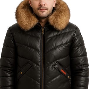 May include: Black leather jacket with a brown fur-lined hood. The jacket has a quilted design, a zipper closure, and a ribbed hem. The jacket has a small orange accent on the pocket.
