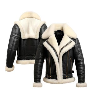May include: Black leather jacket with a cream-colored shearling lining and collar. The jacket features a zip-up front, side pockets, and a buckled belt at the waist. The cuffs are also lined with shearling.