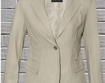 May include: A pale beige leather blazer with a single-button fastening and two front pockets. The blazer features a classic notched lapel and a tailored fit. The jacket is displayed against a grey brick wall.