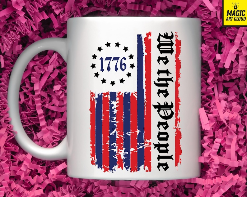 May include: White ceramic mug featuring a distressed American flag design. The flag has red and blue stripes with white stars in the top left corner. The text "We the People" is printed vertically on the right side of the flag. The year "1776" is printed in the centre of the stars.
