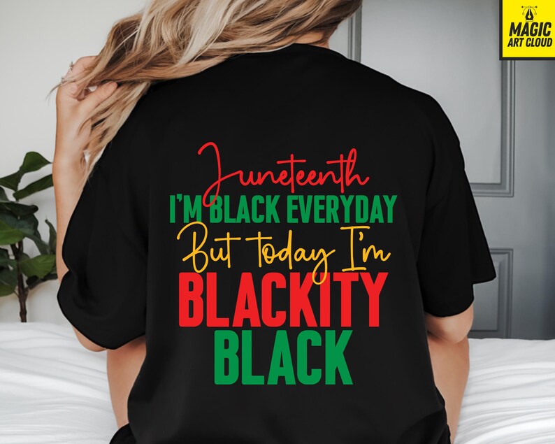 May include: Black t-shirt with the text "Juneteenth" in red script, followed by "I'M BLACK EVERYDAY" in green, "But Today I'm" in yellow, and "BLACKITY BLACK" in red and green. The shirt is a casual style.