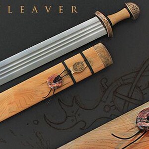 May include: A collection of Viking-style swords with wooden handles and sheaths. The blades are silver, and the handles and sheaths have bronze and leather accents. The text "THE TROLL CLEAVER" is at the top.