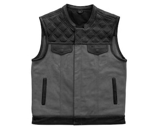 May include: A gray and black leather motorcycle vest with a quilted design on the shoulders and back. The vest has a zipper closure and two pockets on the front.