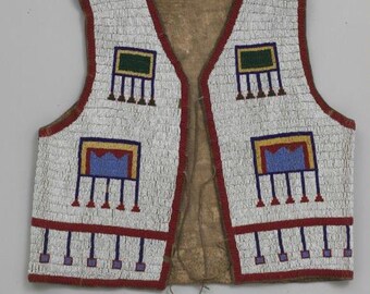 May include: A white beaded vest with red trim and geometric designs in blue, yellow, and green. The vest has a V-neck and a brown leather backing. The beaded patterns are symmetrical and repeat across the front.