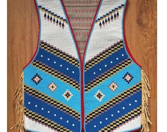 May include: A beaded vest with a geometric pattern in white, blue, and black. The vest has a red trim and fringe along the bottom. The design includes diamond and zig-zag patterns.