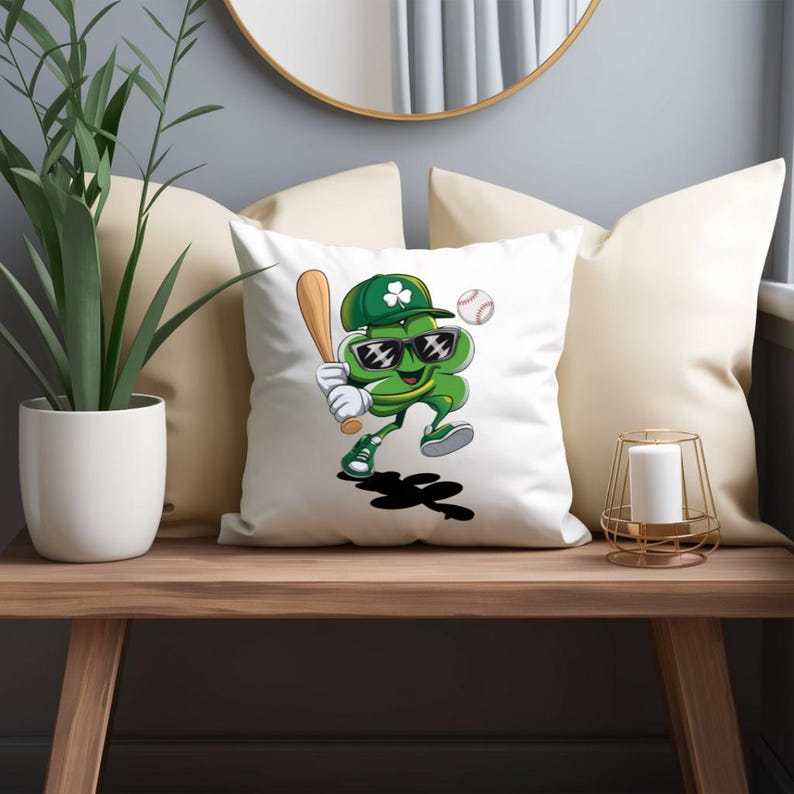 May include: A white cushion featuring a green shamrock wearing sunglasses and a baseball cap, holding a baseball bat. The shamrock is smiling and has a baseball behind it.