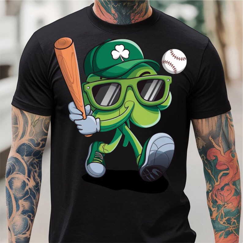 May include: A black t-shirt featuring a green cartoon clover wearing sunglasses and a baseball cap, holding a baseball bat and a baseball.
