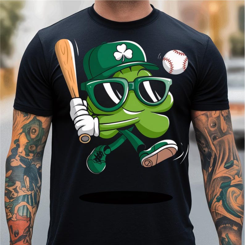 May include: A black t-shirt featuring a green cartoon shamrock wearing sunglasses and a baseball cap, holding a baseball bat and running with a baseball in the air.