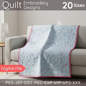 May include: A light blue quilt with pink trim and embroidered paper airplane and heart designs. The quilt is draped over a gray sofa. The text "Quilt Embroidery Designs 20 Sizes" is visible. The words "Digital File" are also visible.