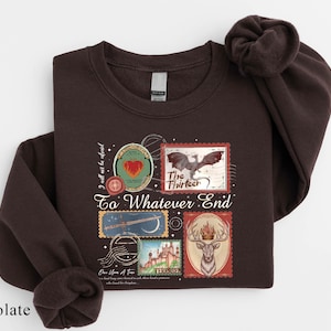 A dark brown sweatshirt with a printed design on the front, featuring various images and text related to the "To Whatever End" series.