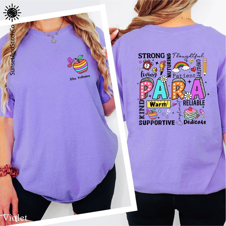 A woman wearing a purple t-shirt with a colorful graphic design and text on the back.